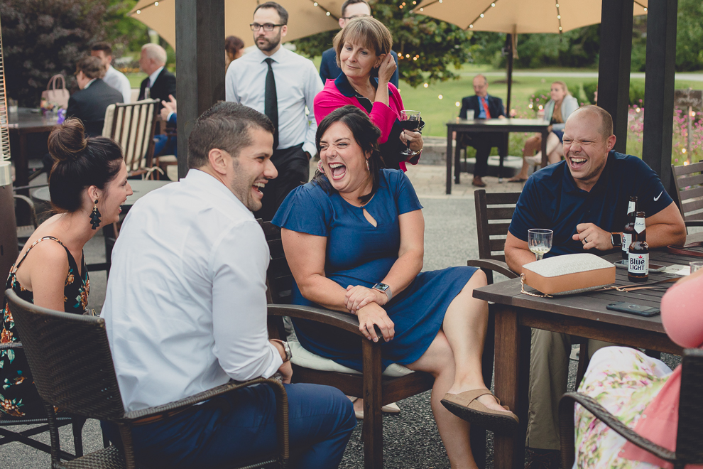 guests laugh outside wedding reception in barn at a Hayloft in the Grove in East Aurora, near Buffalo, NY