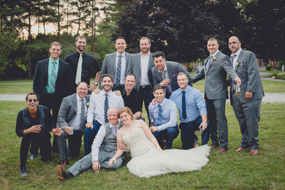 guests pose for photo outside wedding reception in barn at a Hayloft in the Grove in East Aurora, near Buffalo, NY