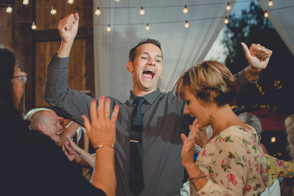 guests dance at wedding reception in barn at a Hayloft in the Grove in East Aurora, near Buffalo, NY