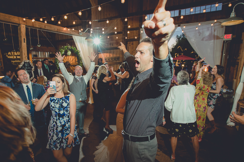 guests dance at wedding reception in barn at a Hayloft in the Grove in East Aurora, near Buffalo, NY