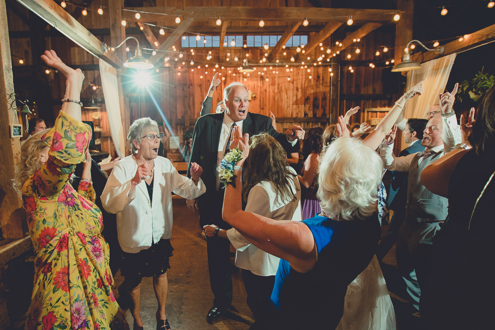 guests dance at wedding reception in barn at a Hayloft in the Grove in East Aurora, near Buffalo, NY
