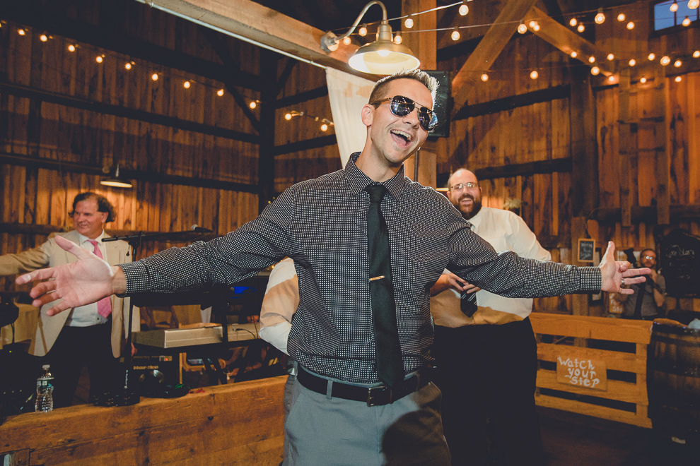 guests dance at wedding reception in barn at a Hayloft in the Grove in East Aurora, near Buffalo, NY