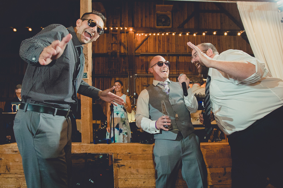 guests dance at wedding reception in barn at a Hayloft in the Grove in East Aurora, near Buffalo, NY