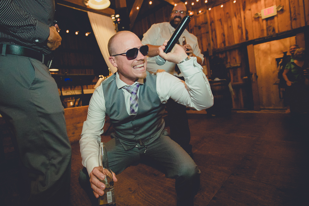 guests dance at wedding reception in barn at a Hayloft in the Grove in East Aurora, near Buffalo, NY