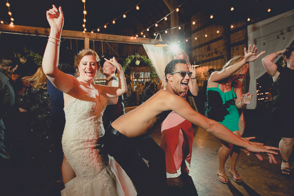 guests dance at wedding reception in barn at a Hayloft in the Grove in East Aurora, near Buffalo, NY