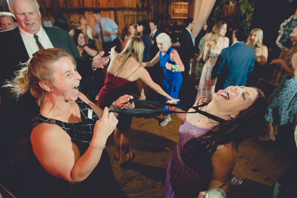guests dance at wedding reception in barn at a Hayloft in the Grove in East Aurora, near Buffalo, NY