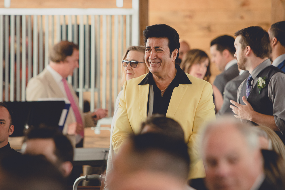 Elvis laughing at wedding ceremony in converted stables at a Hayloft in the Grove wedding in East Aurora, near Buffalo, NY