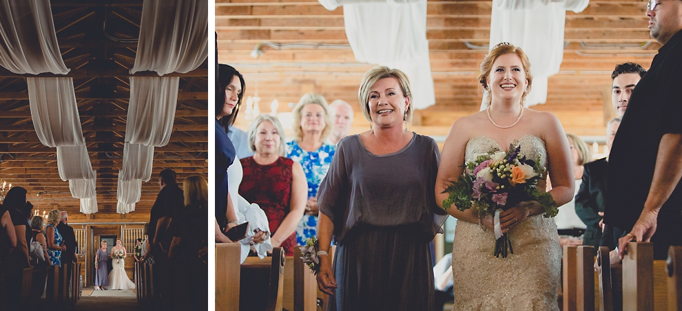 bride and mom walk down aisle at wedding ceremony in converted stables at a Hayloft in the Grove wedding in East Aurora, near Buffalo, NY