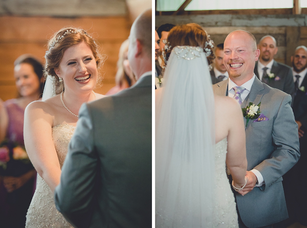 bride and groom smile at each other at wedding ceremony in converted stables at a Hayloft in the Grove in East Aurora, near Buffalo, NY