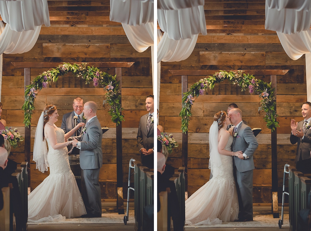 bride and groom kiss at wedding ceremony in converted stables at a Hayloft in the Grove in East Aurora, near Buffalo, NY