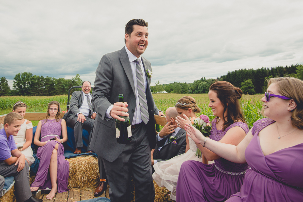 wedding party takes hayride to sunken pond for portraits at a Hayloft in the Grove in East Aurora, near Buffalo, NY