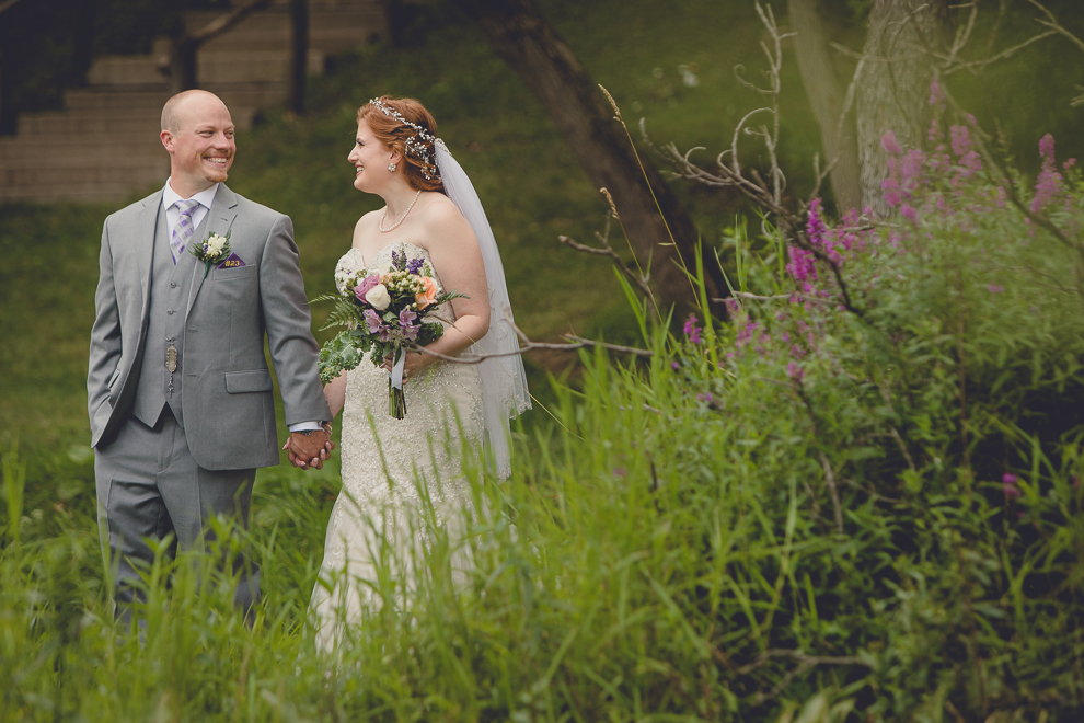 bride and groom pose for portraits at sunken pond at a Hayloft in the Grove in East Aurora, near Buffalo, NY