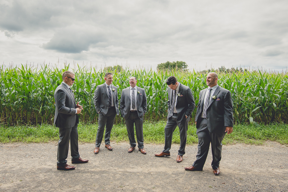bridal party poses for portraits at sunken pond at a Hayloft in the Grove in East Aurora, near Buffalo, NY