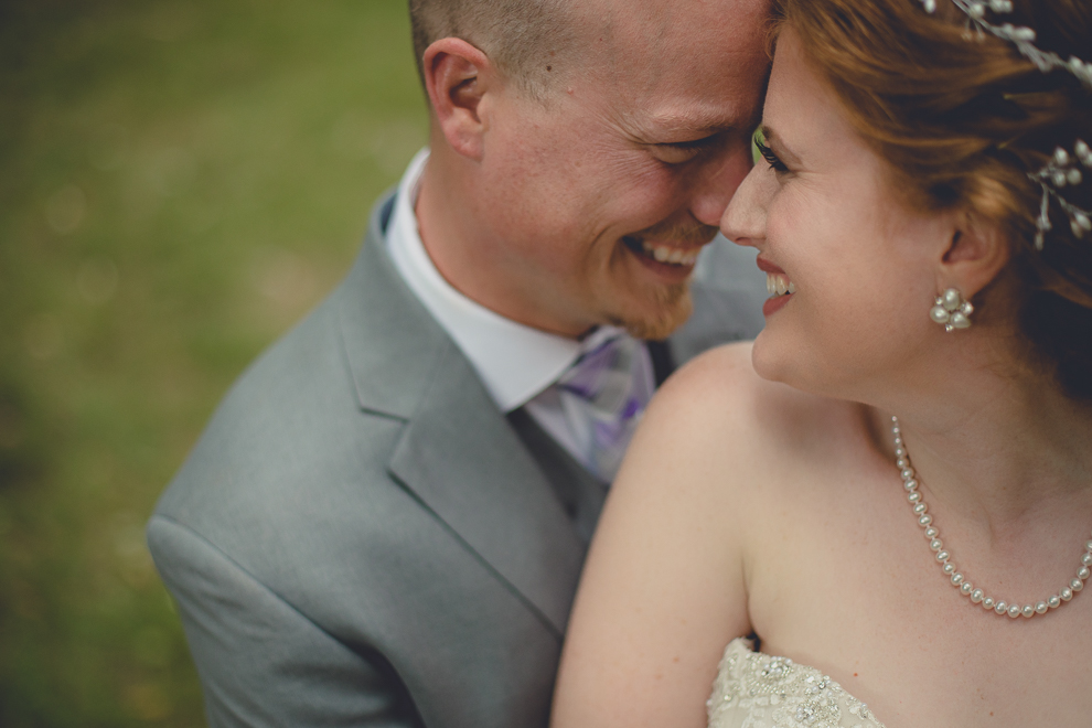 bride and groom pose for portraits at sunken pond at a Hayloft in the Grove in East Aurora, near Buffalo, NY