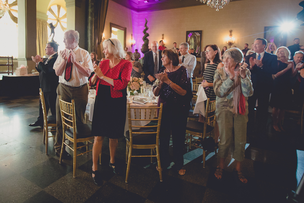 guests clap for bride and groom in Terrace Room at the Statler City wedding reception venue in Buffalo, NY