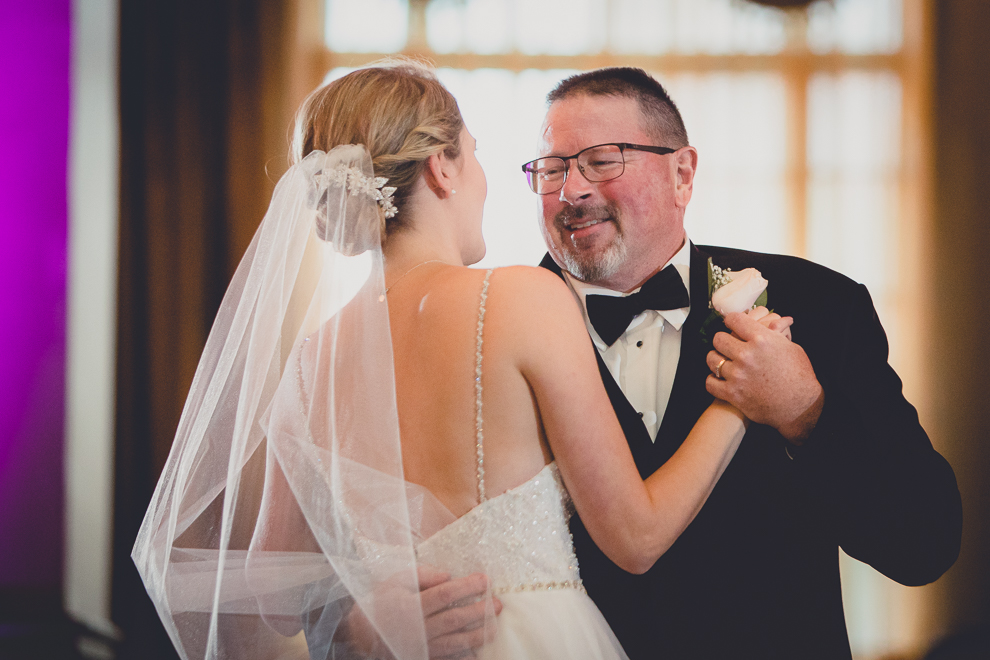 father smiles at bride during first dance in Terrace Room at the Statler City wedding reception venue in Buffalo, NY