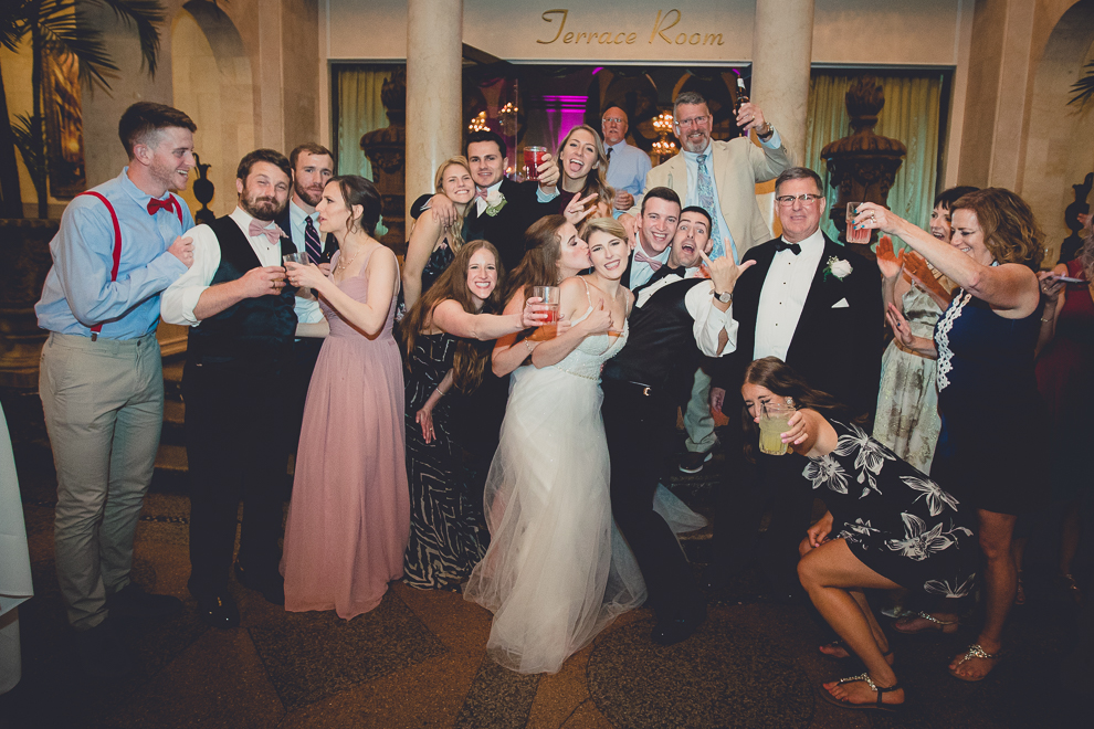 guests pose for portrait with photographer in Terrace Room at the Statler City wedding reception venue in Buffalo, NY