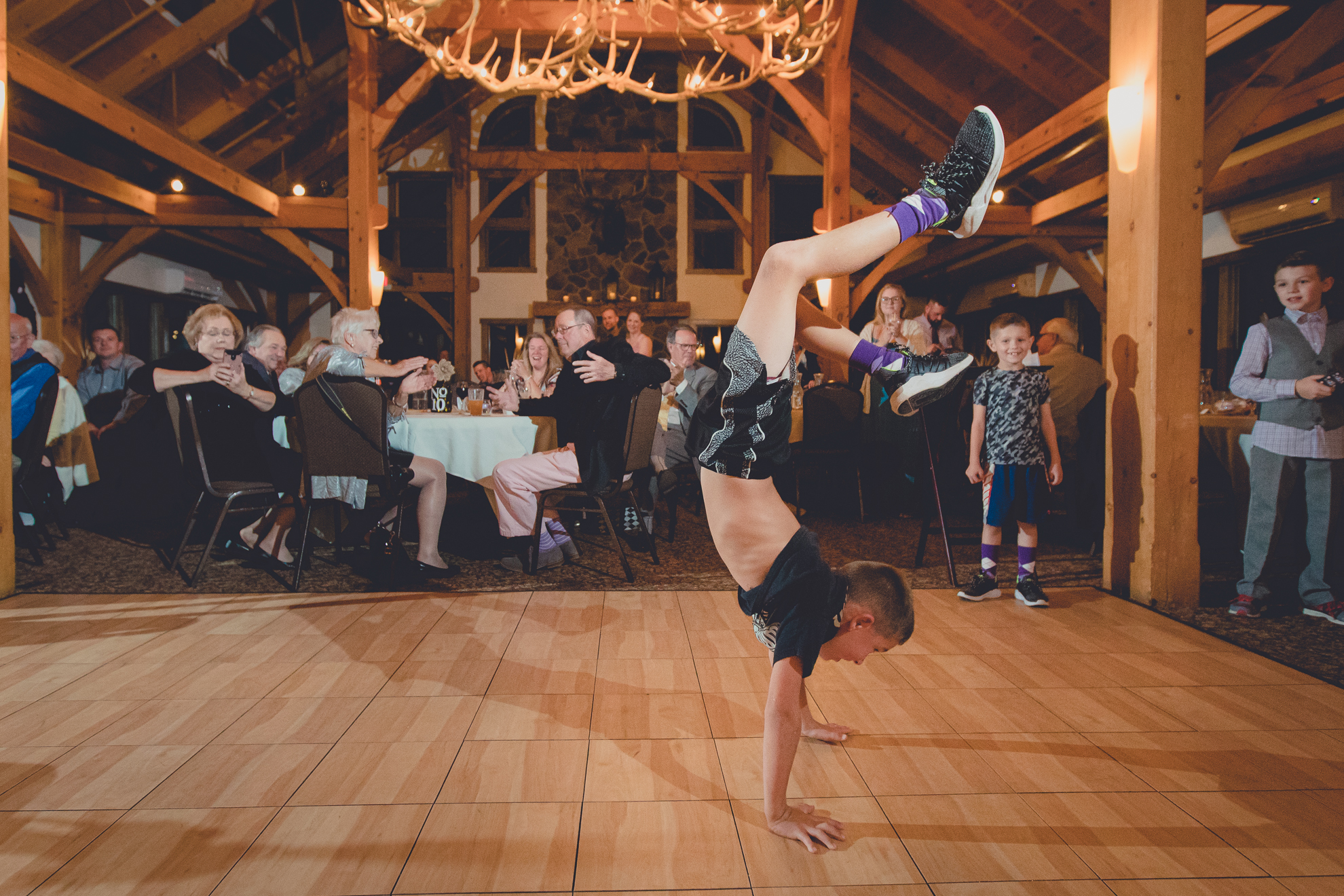 guests dance in lodge at wedding at hidden valley animal adventure near Buffalo, NY