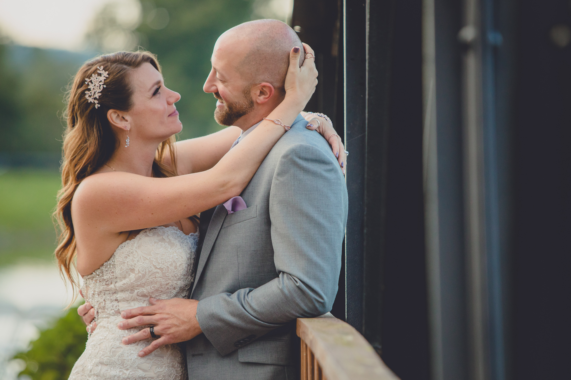 bride and groom pose for wedding portraits in rain at their wedding at hidden valley animal adventure near Buffalo, NY