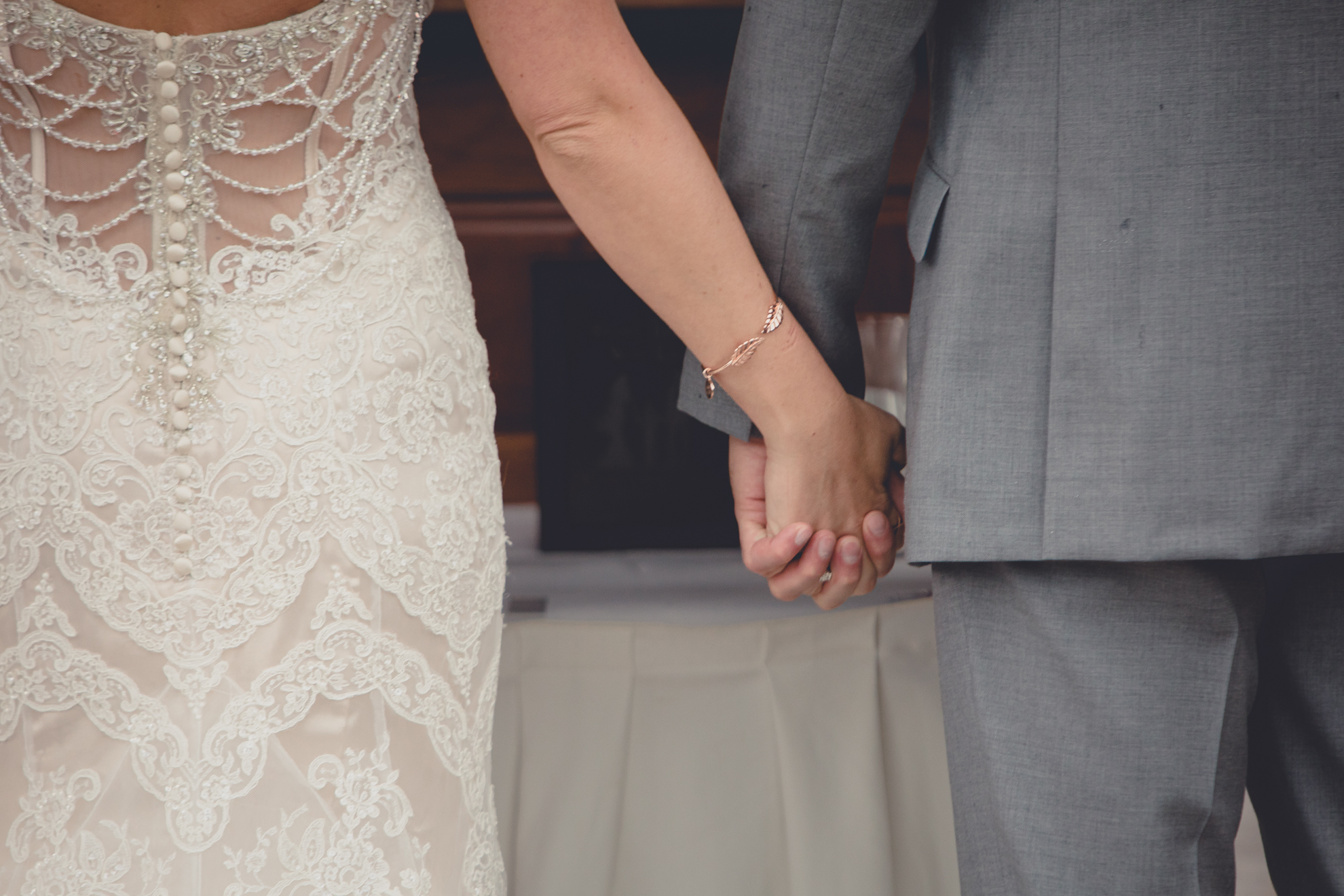 photography of bride and groom holding hands at wedding ceremony at hidden valley animal adventure near Buffalo, NY