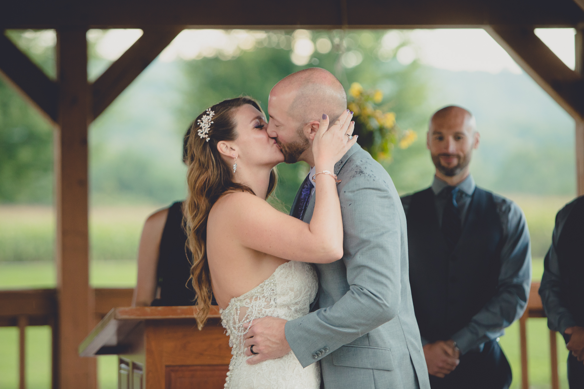 photography of bride and groom kissing at wedding ceremony at hidden valley animal adventure near Buffalo, NY