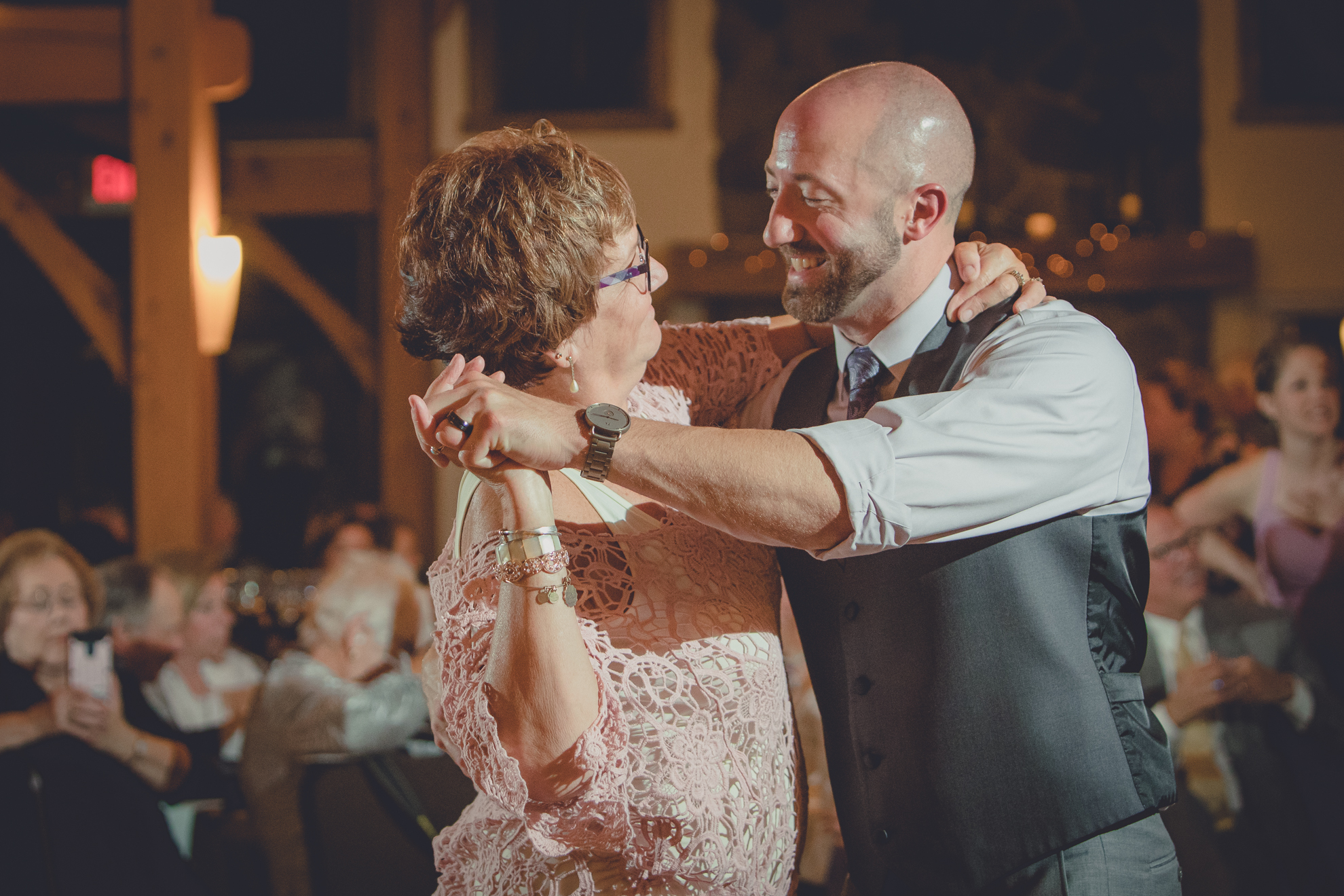 groom dances with mother in lodge at wedding at hidden valley animal adventure near Buffalo, NY