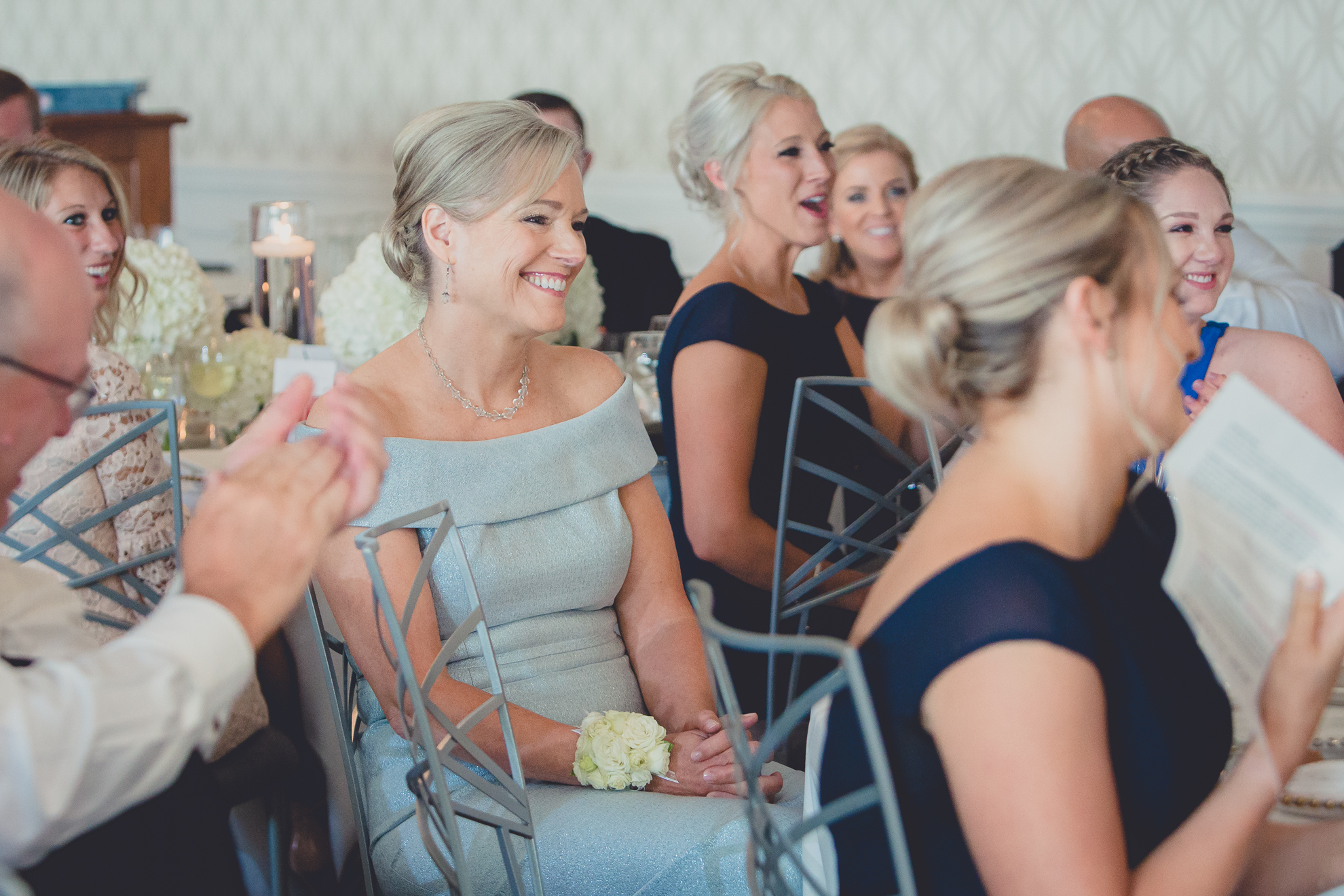 mom laughs during speech at wedding reception at Niagara Falls Country Club in Lewiston, NY