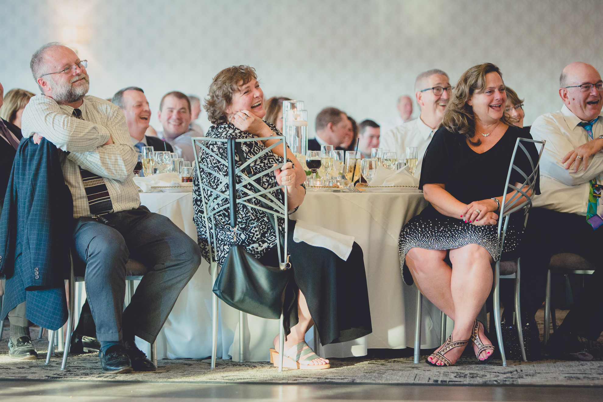guests laugh at wedding reception at Niagara Falls Country Club in Lewiston, NY