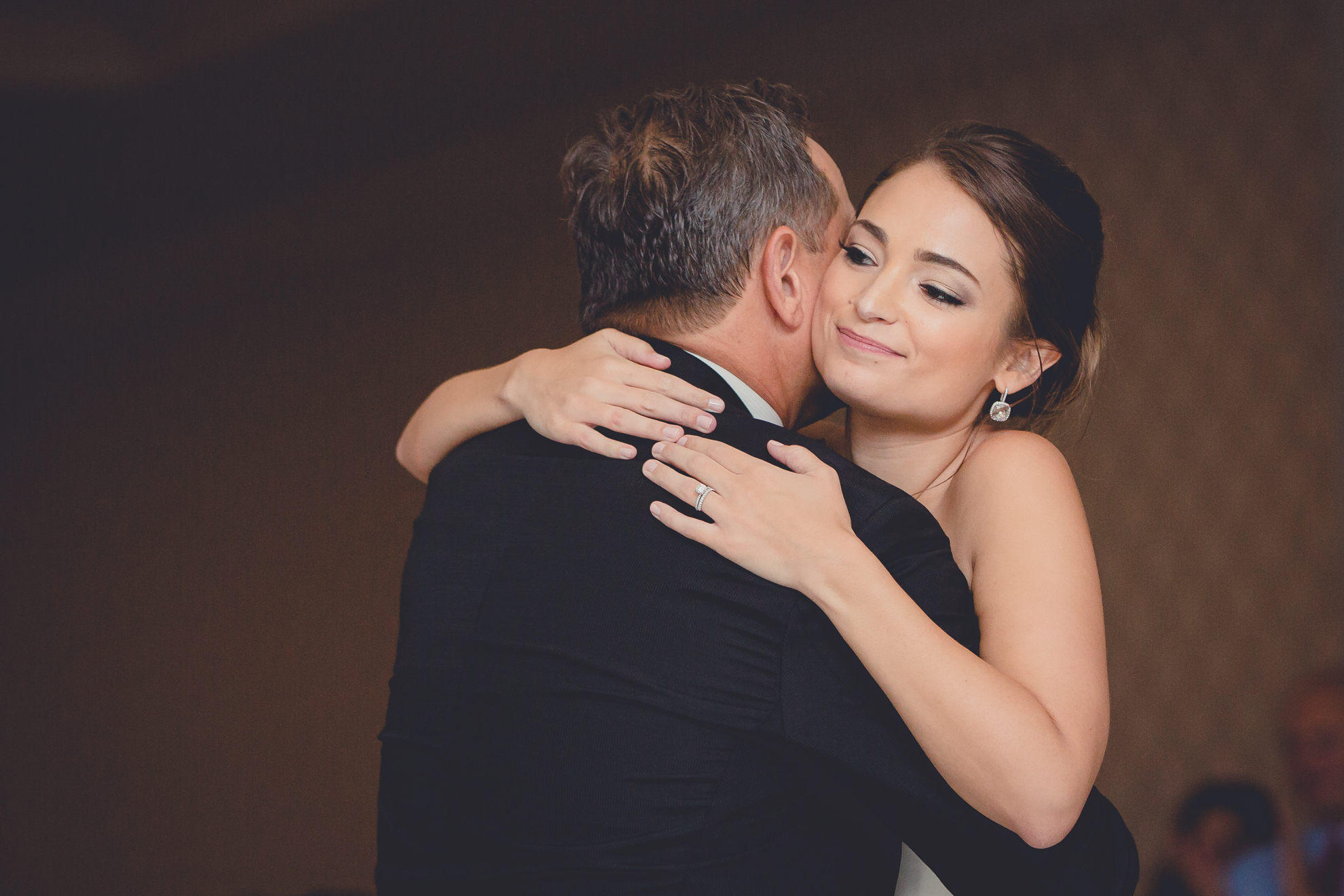 bride hugs father after dance at wedding reception at Niagara Falls Country Club in Lewiston, NY