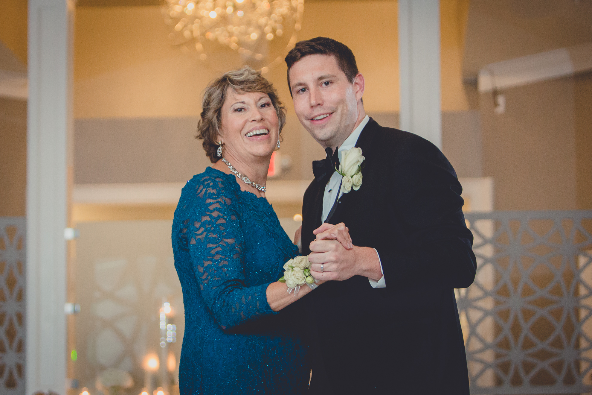 groom and mother smile for photographer at wedding reception at Niagara Falls Country Club in Lewiston, NY