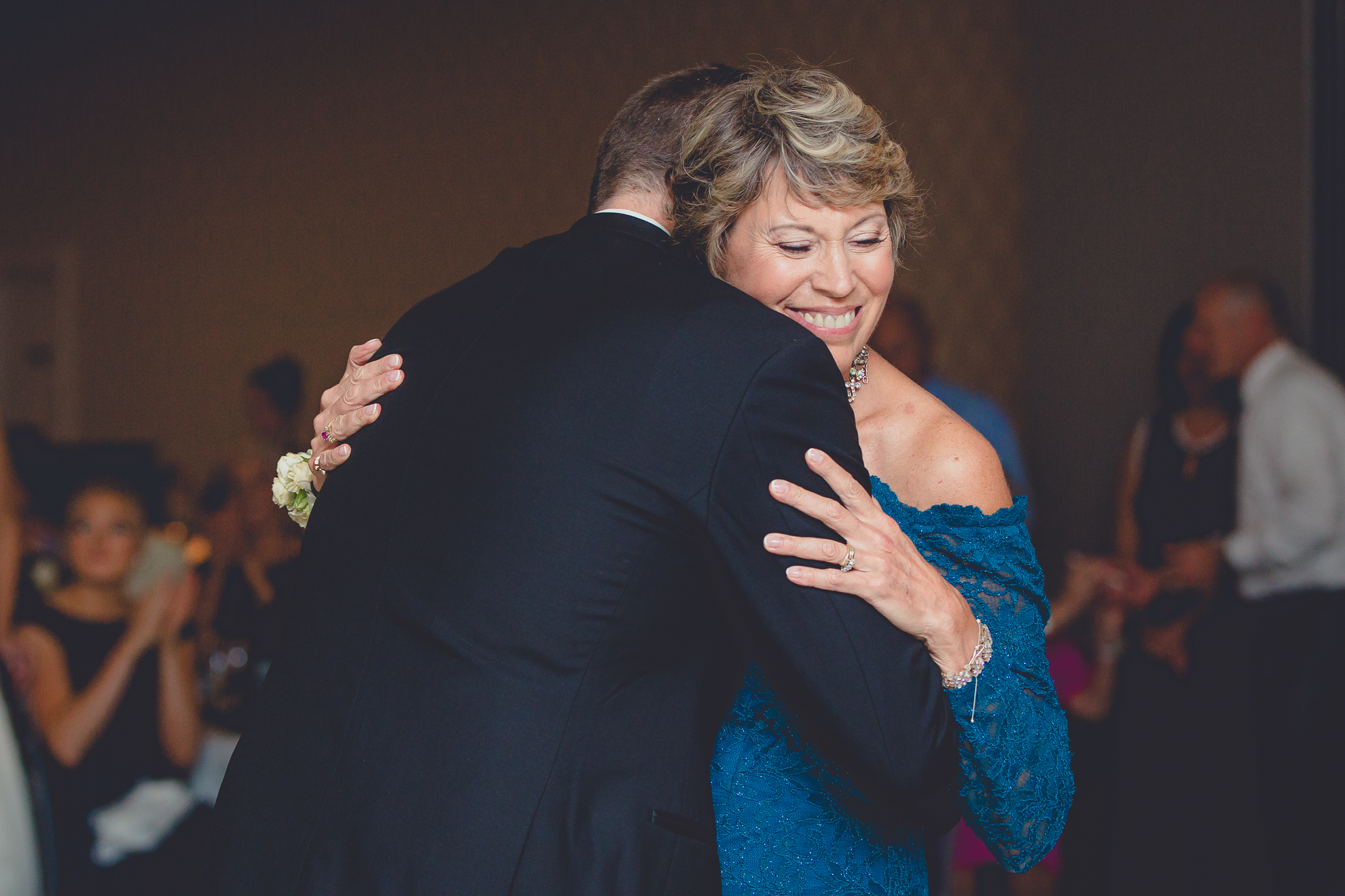 groom hugs mom after dance at wedding reception at Niagara Falls Country Club in Lewiston, NY