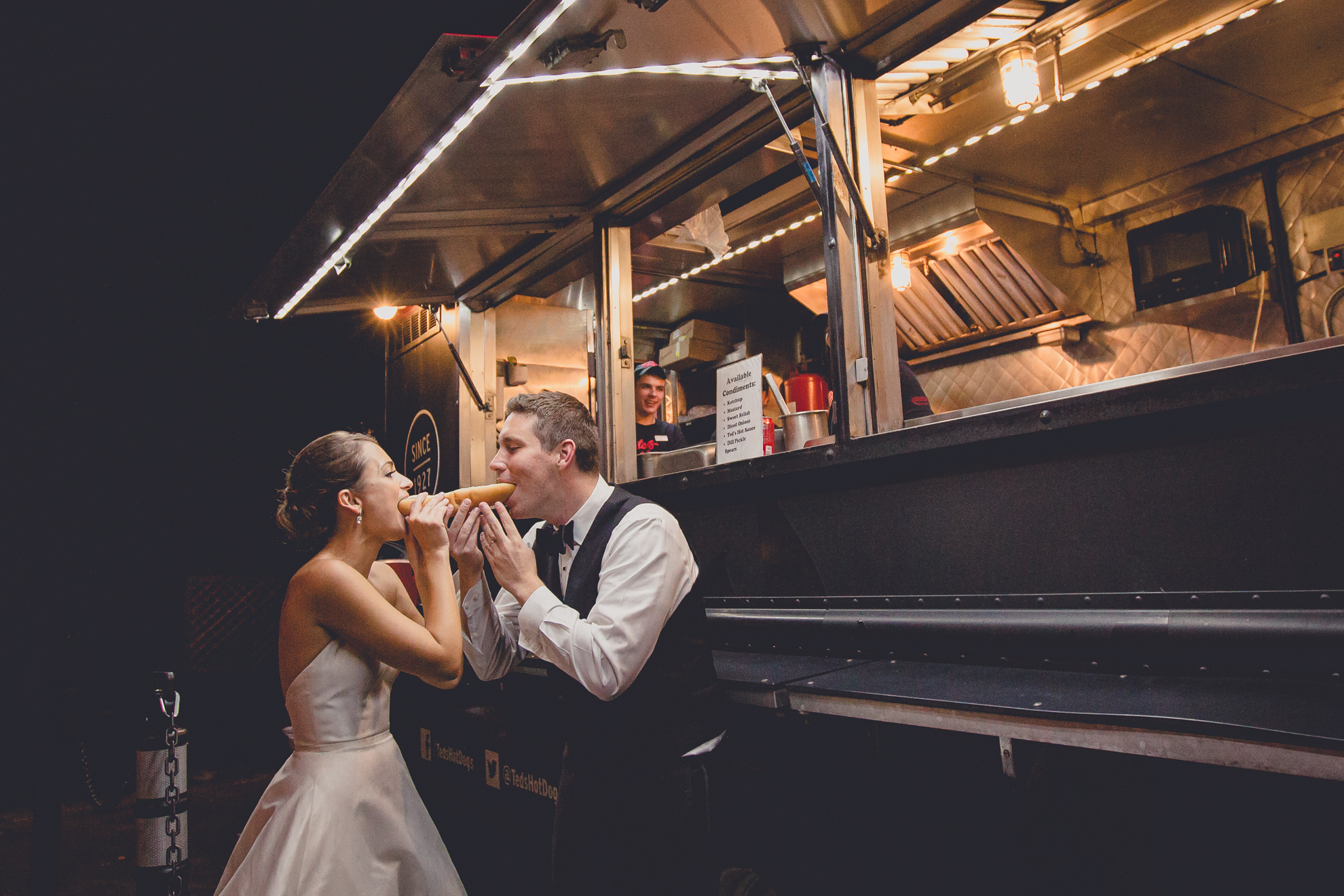 bride and groom share Ted's foot long hot dog in front of their truck at wedding reception at Niagara Falls Country Club in Lewiston, NY