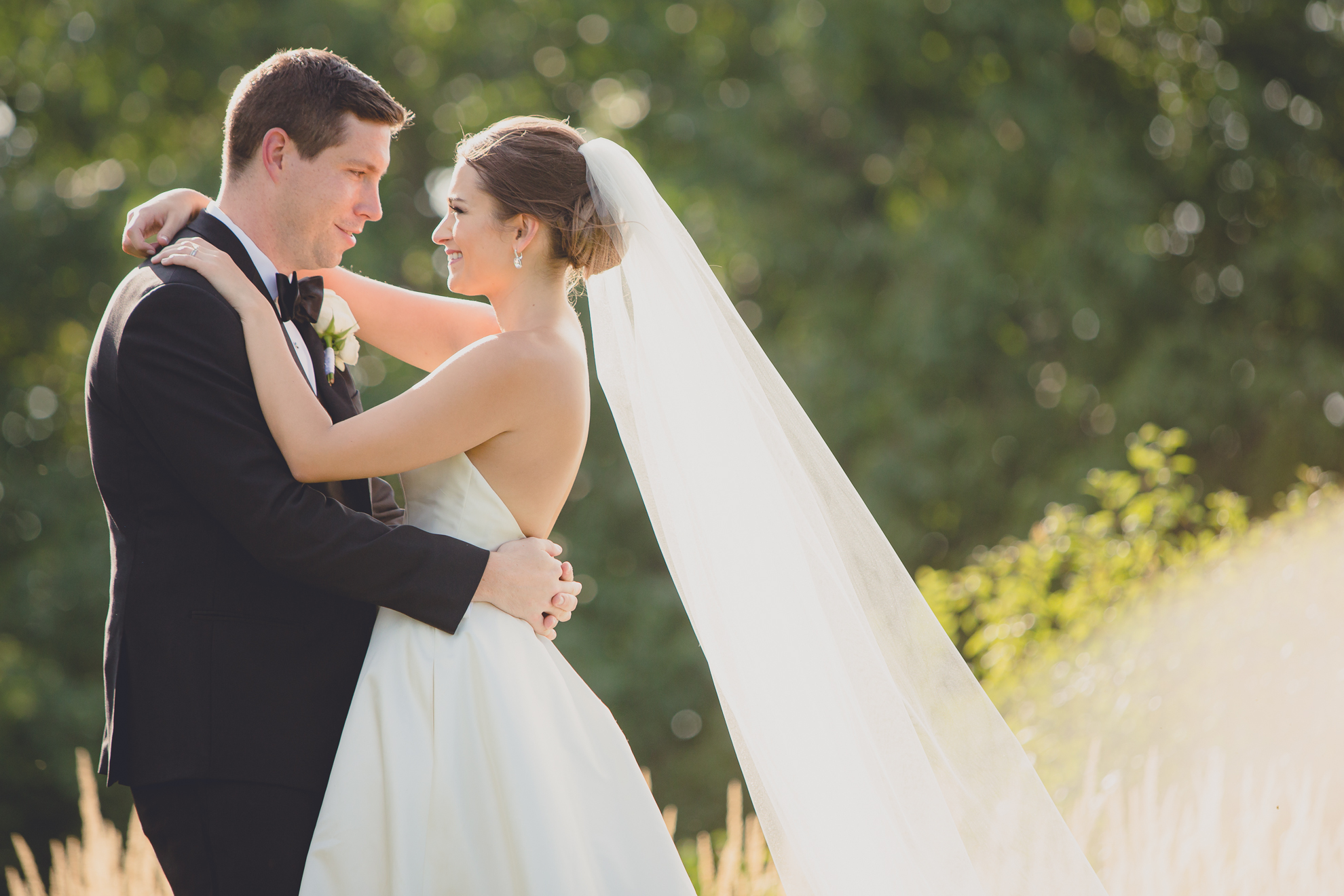 bride and groom smile at each other before wedding reception at Niagara Falls Country Club near Buffalo, NY
