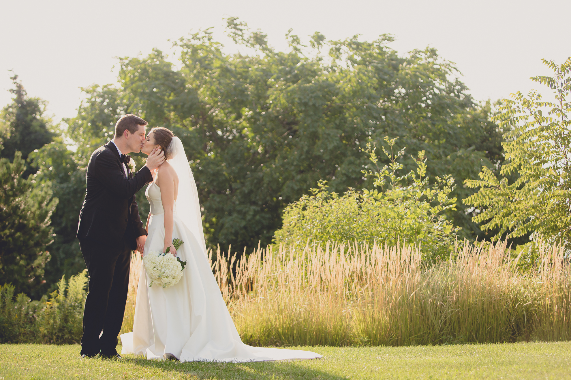 bride and groom kiss before wedding reception at Niagara Falls Country Club near Buffalo, NY
