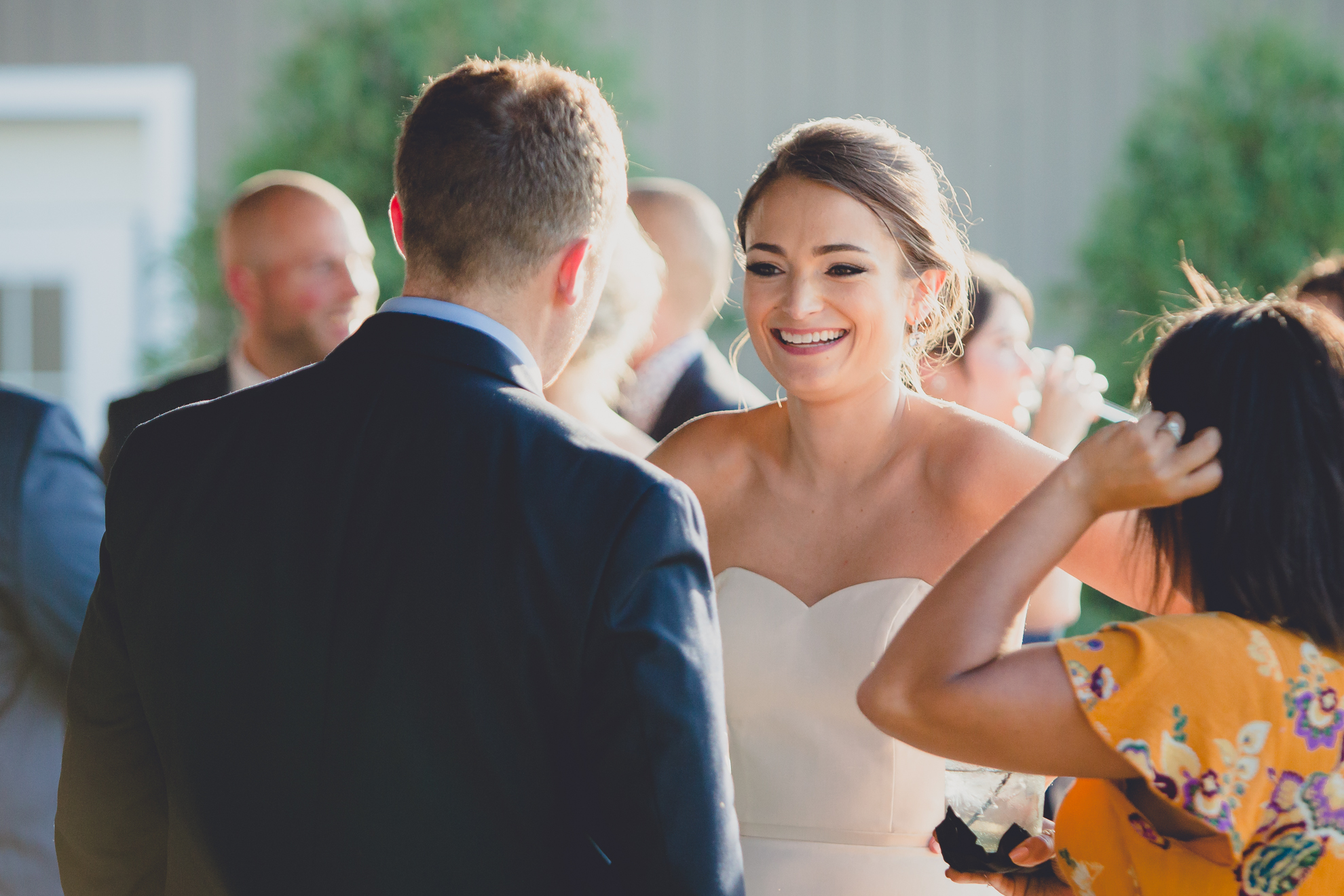 bride smiles during cocktail hour at at wedding reception at Niagara Falls Country Club in Lewiston, NY