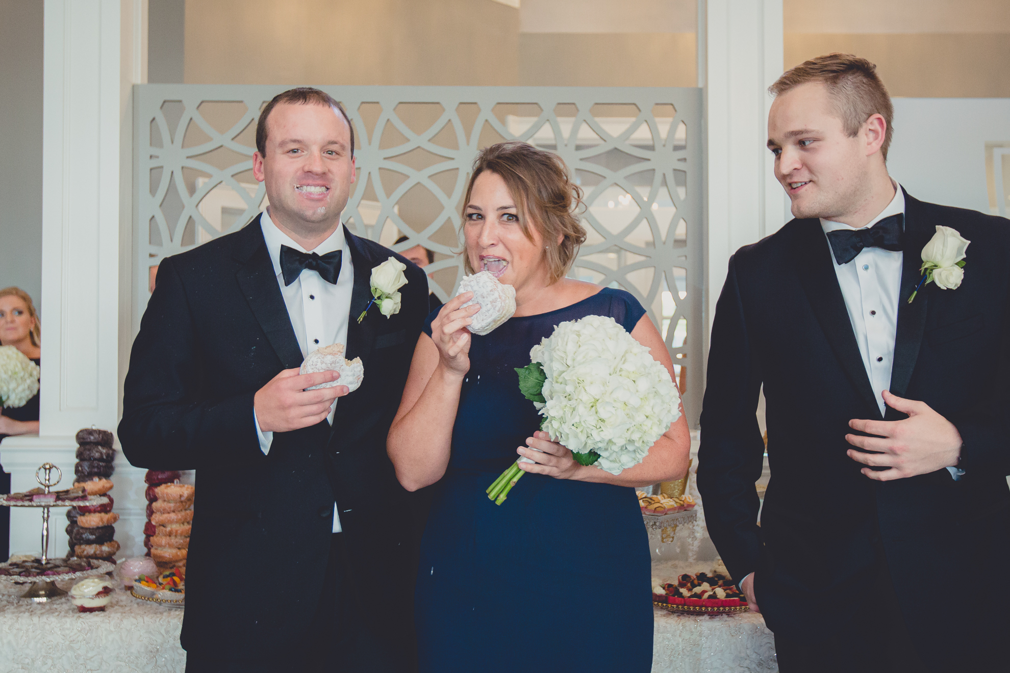 bridal party steals donuts at wedding reception at Niagara Falls Country Club in Lewiston, NY