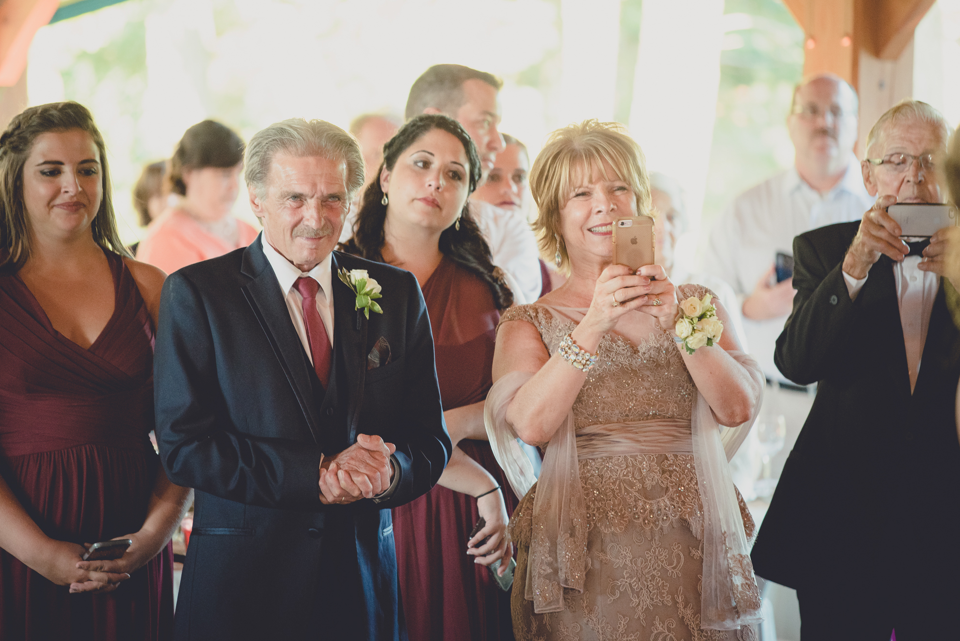 guests take pictures of bride and groom during outdoor wedding reception at Spring Lake Winery venue near Buffalo in WNY