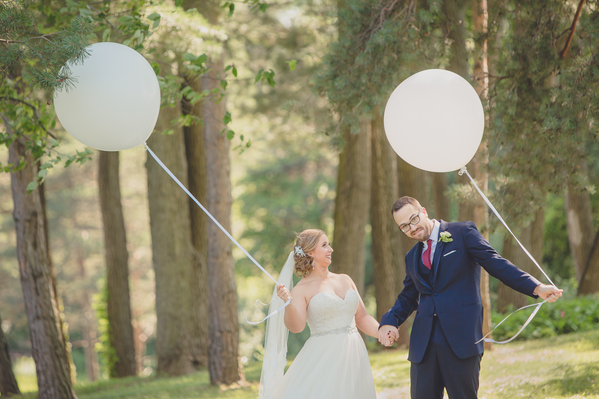 bride and groom pose for portraits with baloons at Spring Lake Winery in Niagara County before WNY wedding