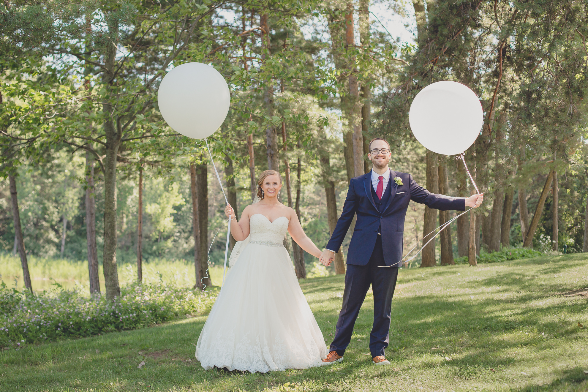 bride and groom pose for portraits with baloons at Spring Lake Winery in Niagara County before WNY wedding