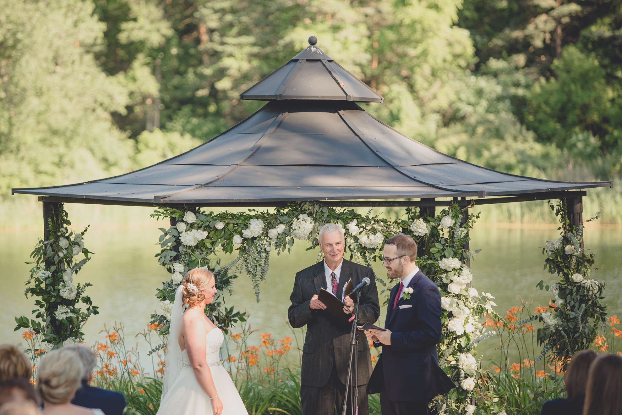 bride and groom recite vows during wedding outdoor wedding ceremony at Spring Lake Winery in Lockport, NY