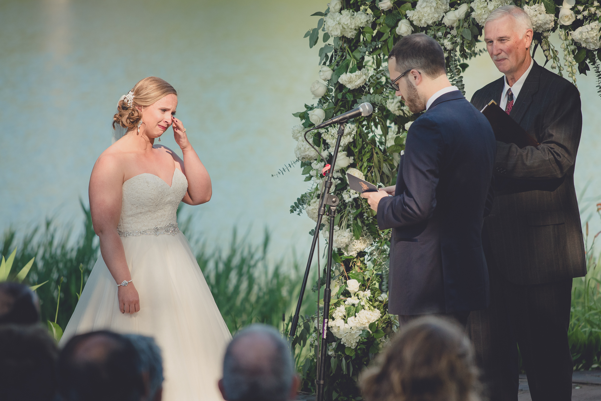 bride cries while saying vows during wedding outdoor wedding ceremony at Spring Lake Winery in Lockport, NY