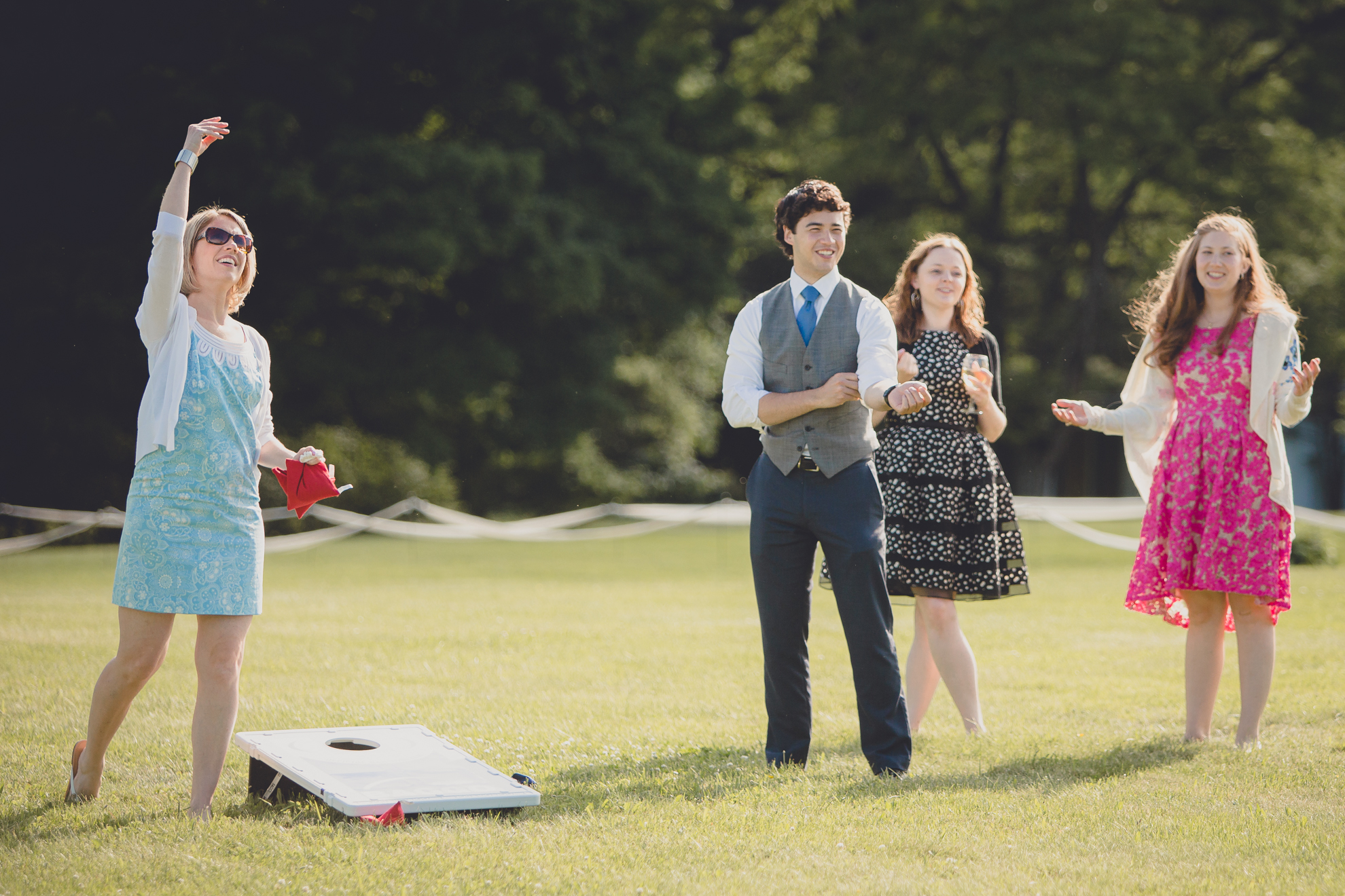 guests enjoy lawn games during cocktail hour at reception at small wedding at Knox Farm near Buffalo, NY