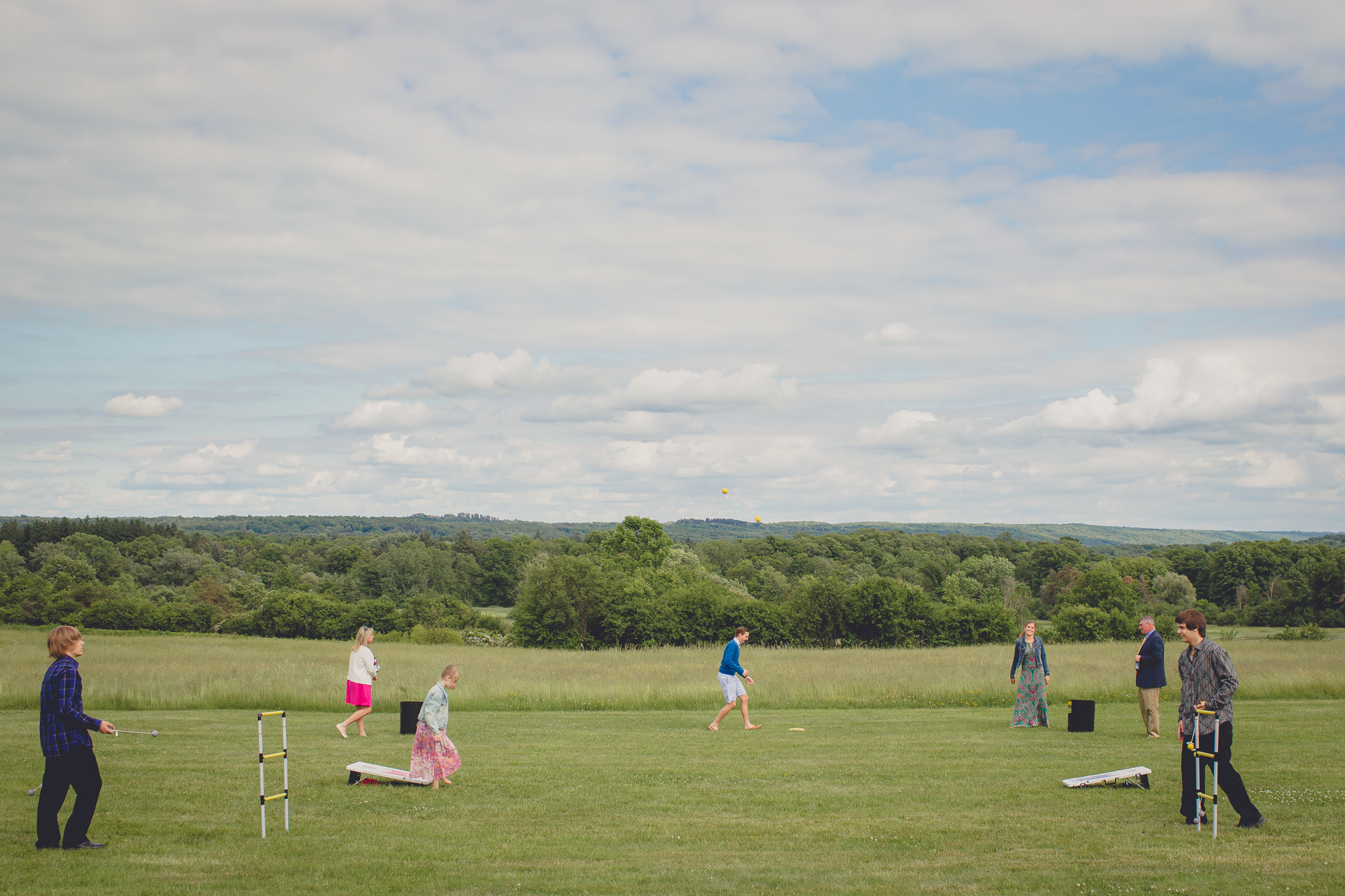 guests enjoy lawn games during cocktail hour at reception at small wedding at Knox Farm near Buffalo, NY