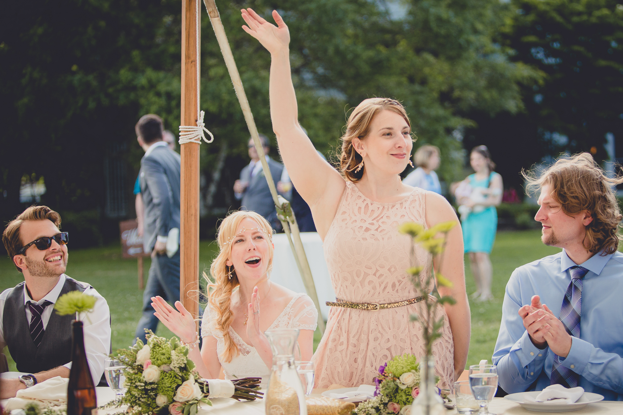 maid of honor waives during wedding party introductions at reception at small wedding at Knox Farm near Buffalo, NY