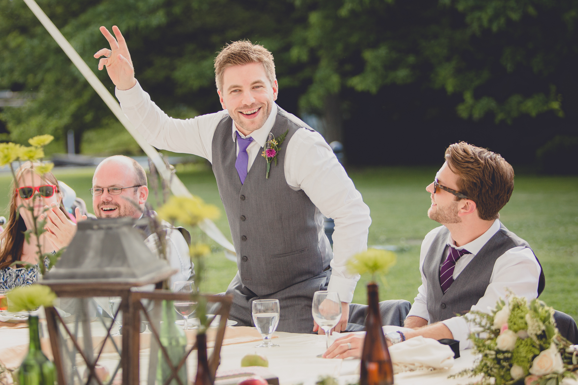 best man waives during wedding party introductions at reception at small wedding at Knox Farm near Buffalo, NY