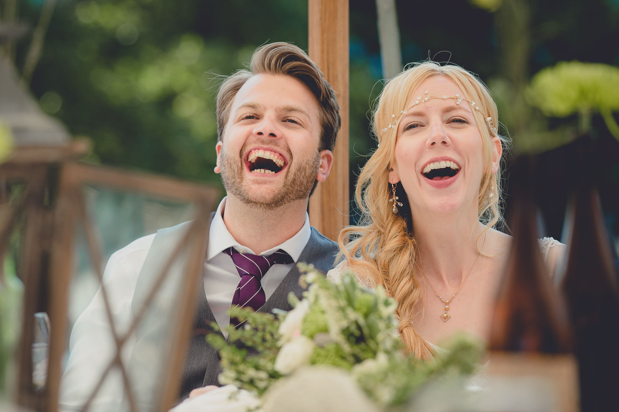 bride and groom laugh during speech under tent at reception at small wedding at Knox Farm near Buffalo, NY