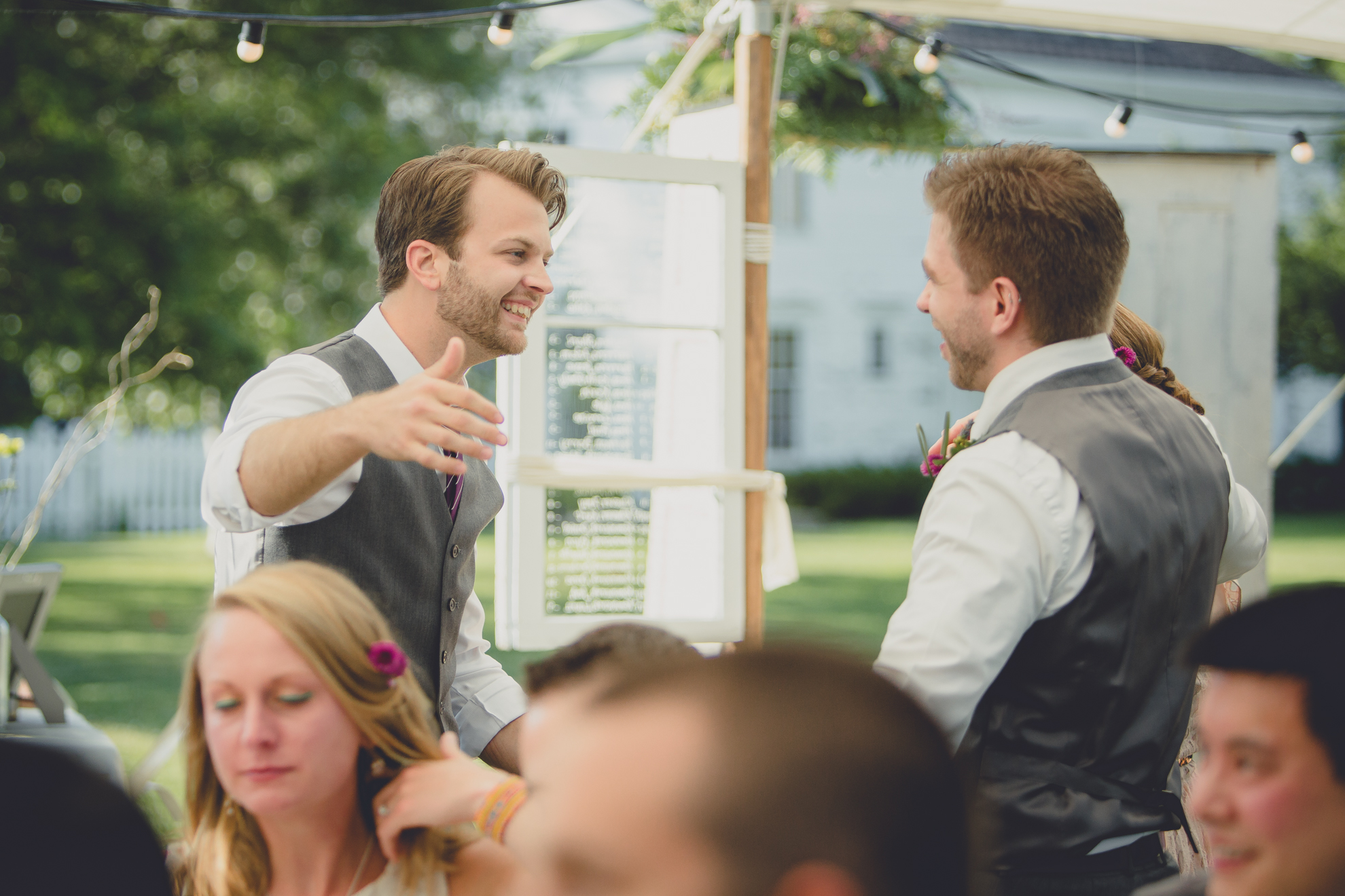 groom hugs best man after speech under tent at reception at small wedding at Knox Farm near Buffalo, NY