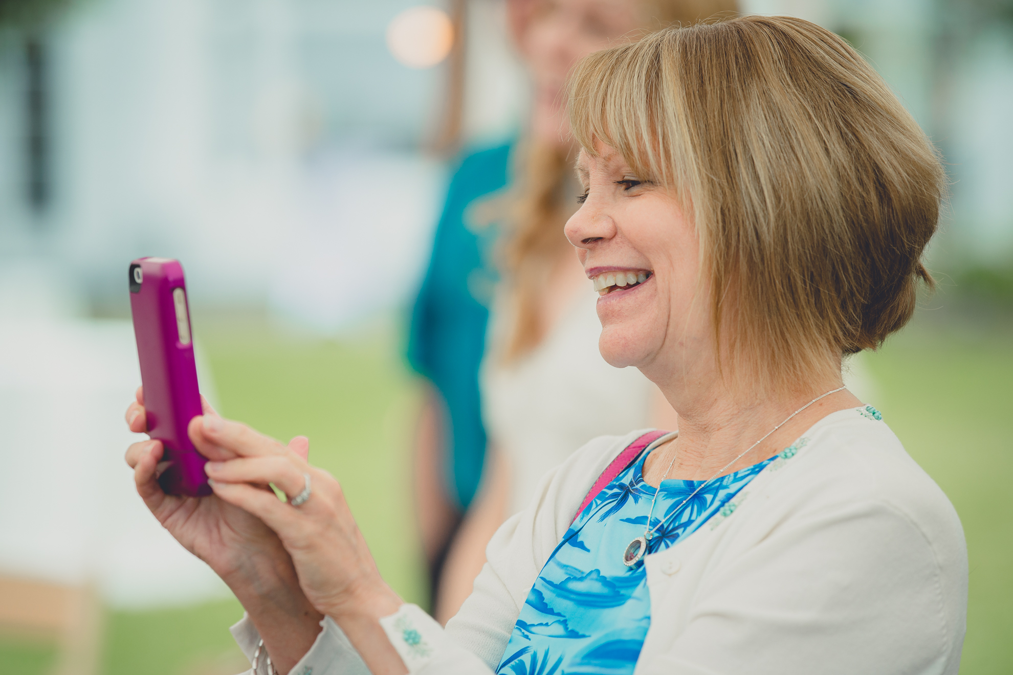 aunt takes photo during tented reception at small wedding at Knox Farm near Buffalo, NY