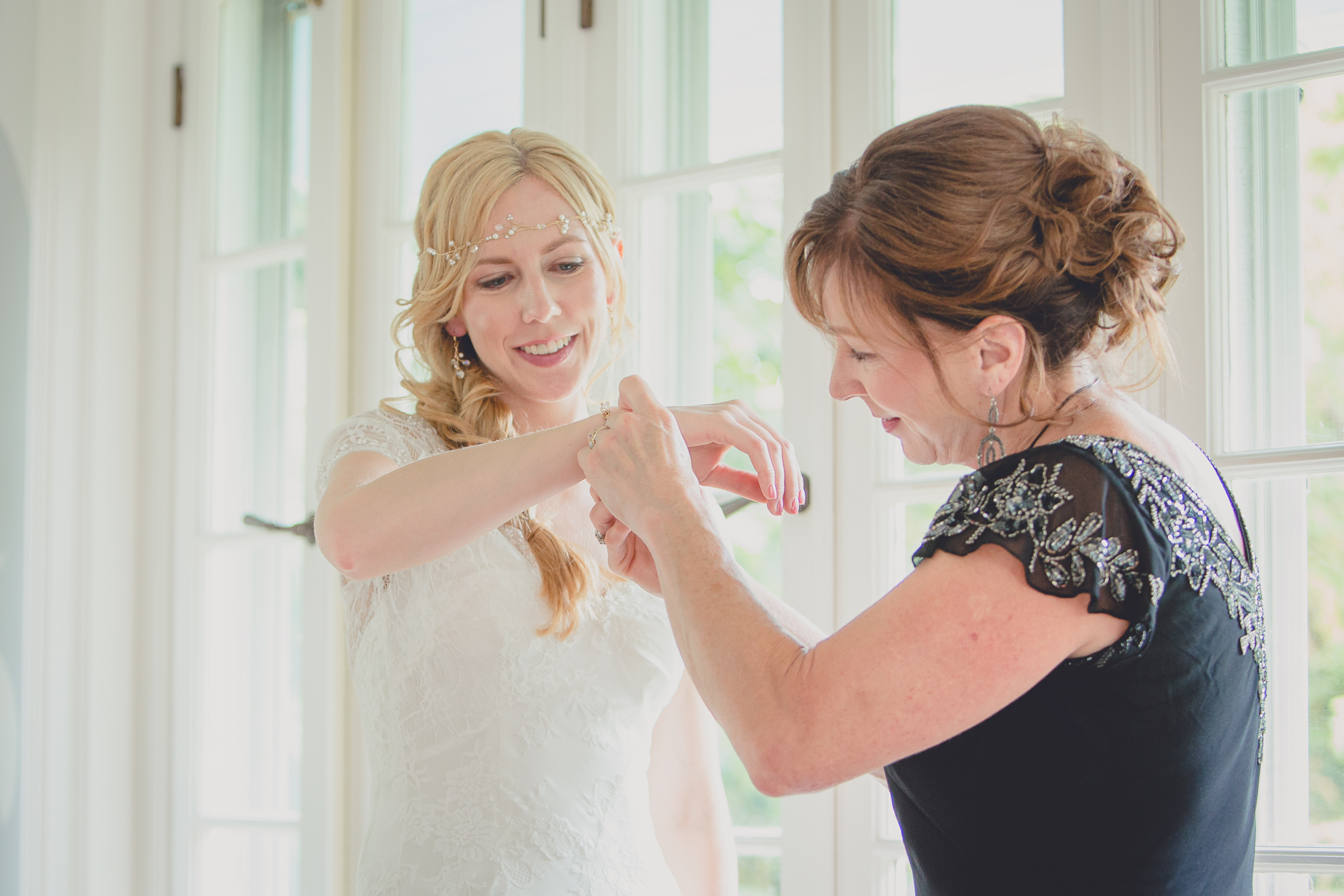 mother of bride help bride get ready in secret room at small wedding at Knox Farm near Buffalo, NY