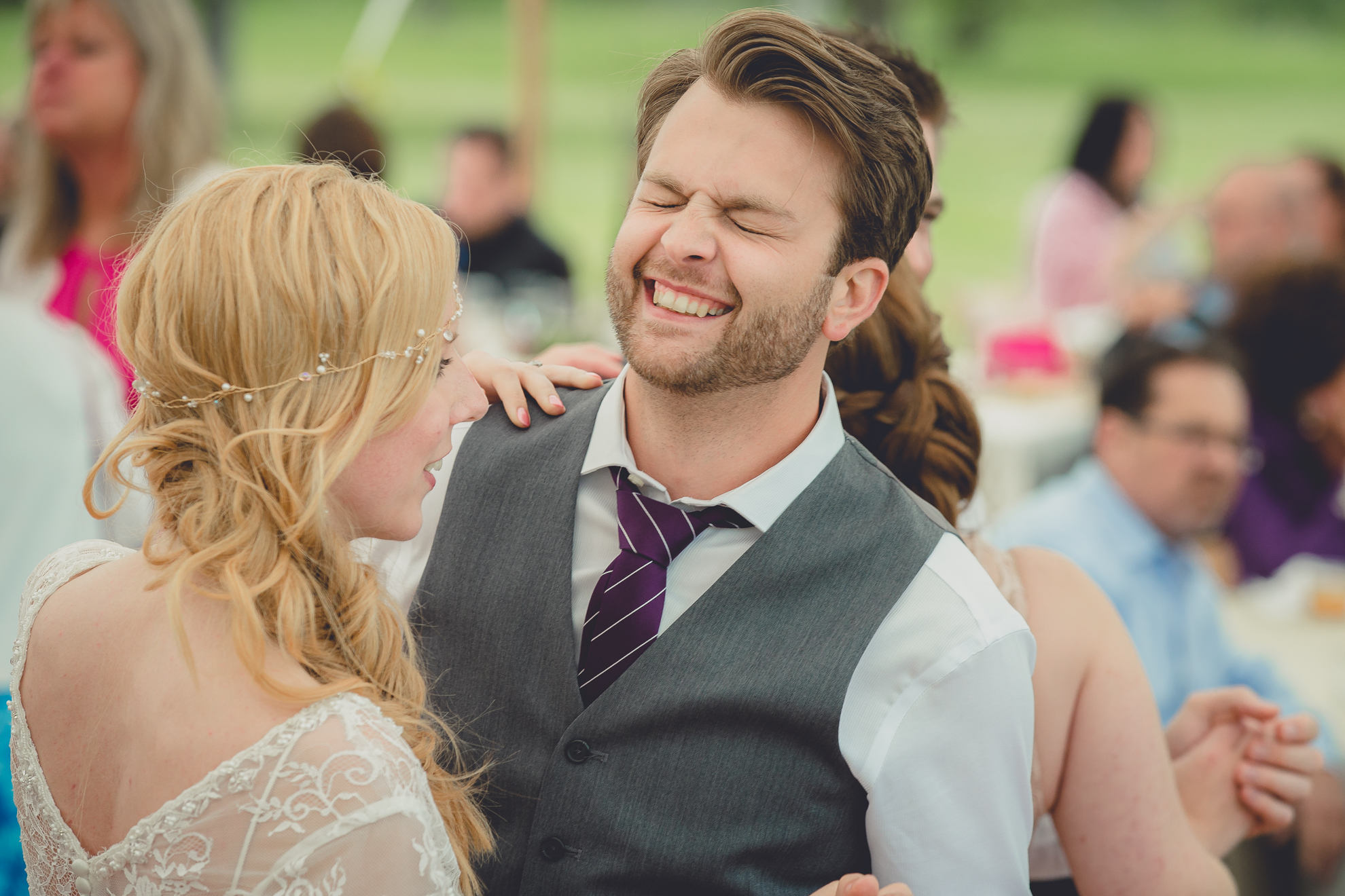 groom laughs during tented reception at small wedding at Knox Farm near Buffalo, NY